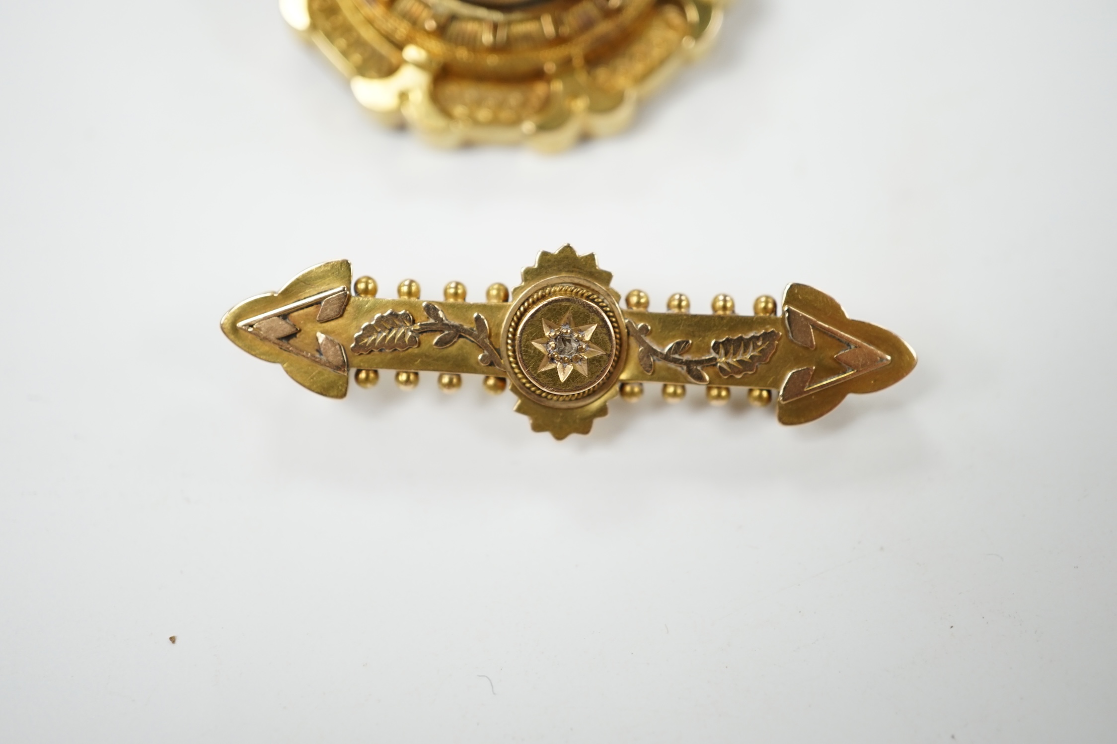 A late Victorian 15ct gold and split pearl set circular brooch, 34mm, gross weight 7.7 grams, together with a yellow metal and diamond chip set bar brooch, gross weight 2.6 grams. Condition - fair